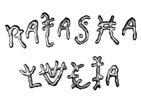 Metallic lettering of 'Ratas' and 'Lucia' on a white background